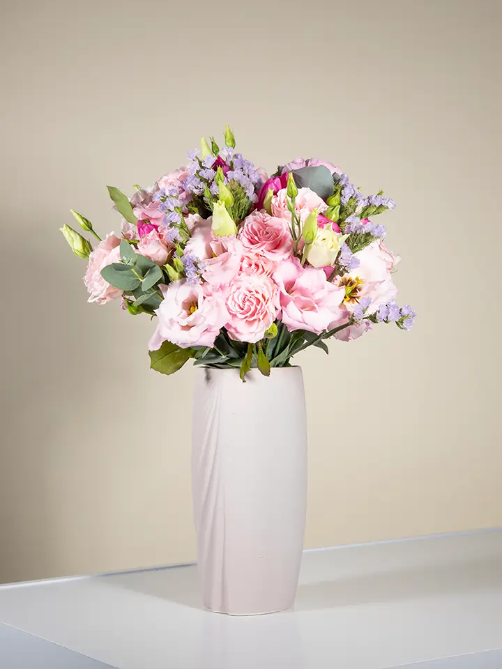 Bouquet rosa pastello di lisianthus garofani statice in vaso